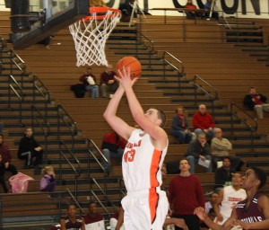 Older brother Trevor shoots the ball at a regional game vs. Danville