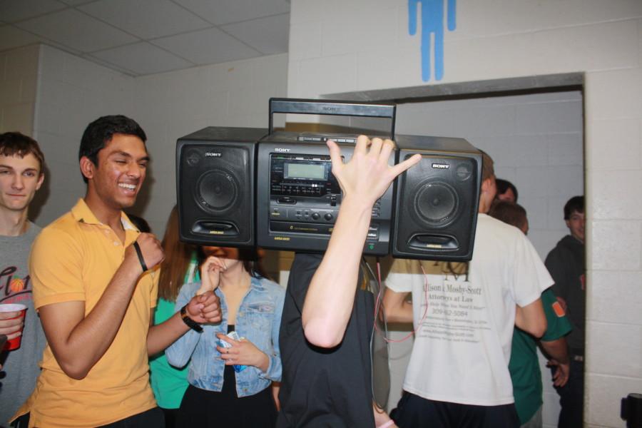 Austin Bloom (12) carrying a boombox into the bathroom 