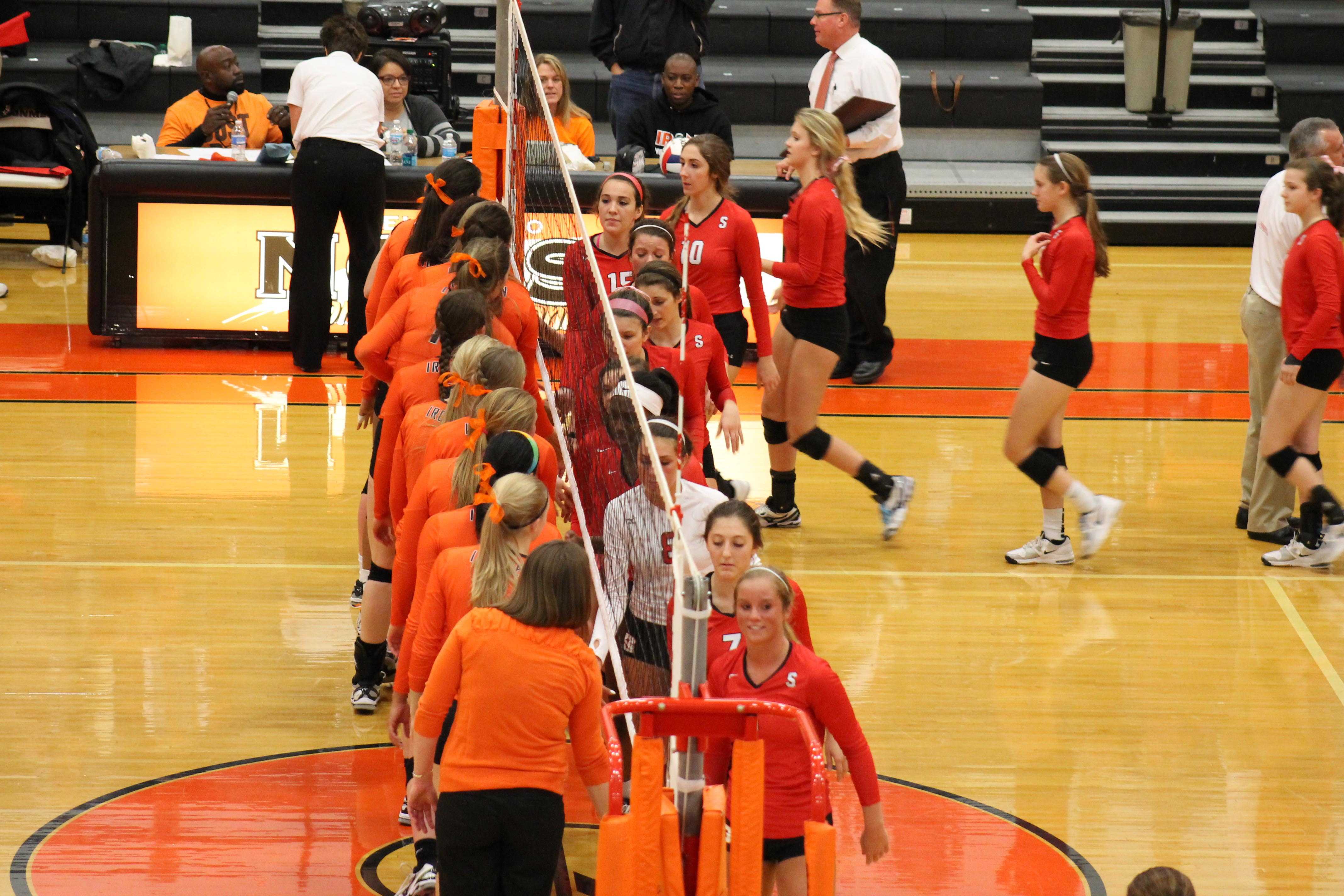 Lady Iron congratulate their opponents after winning the Sectional title in 3 games.