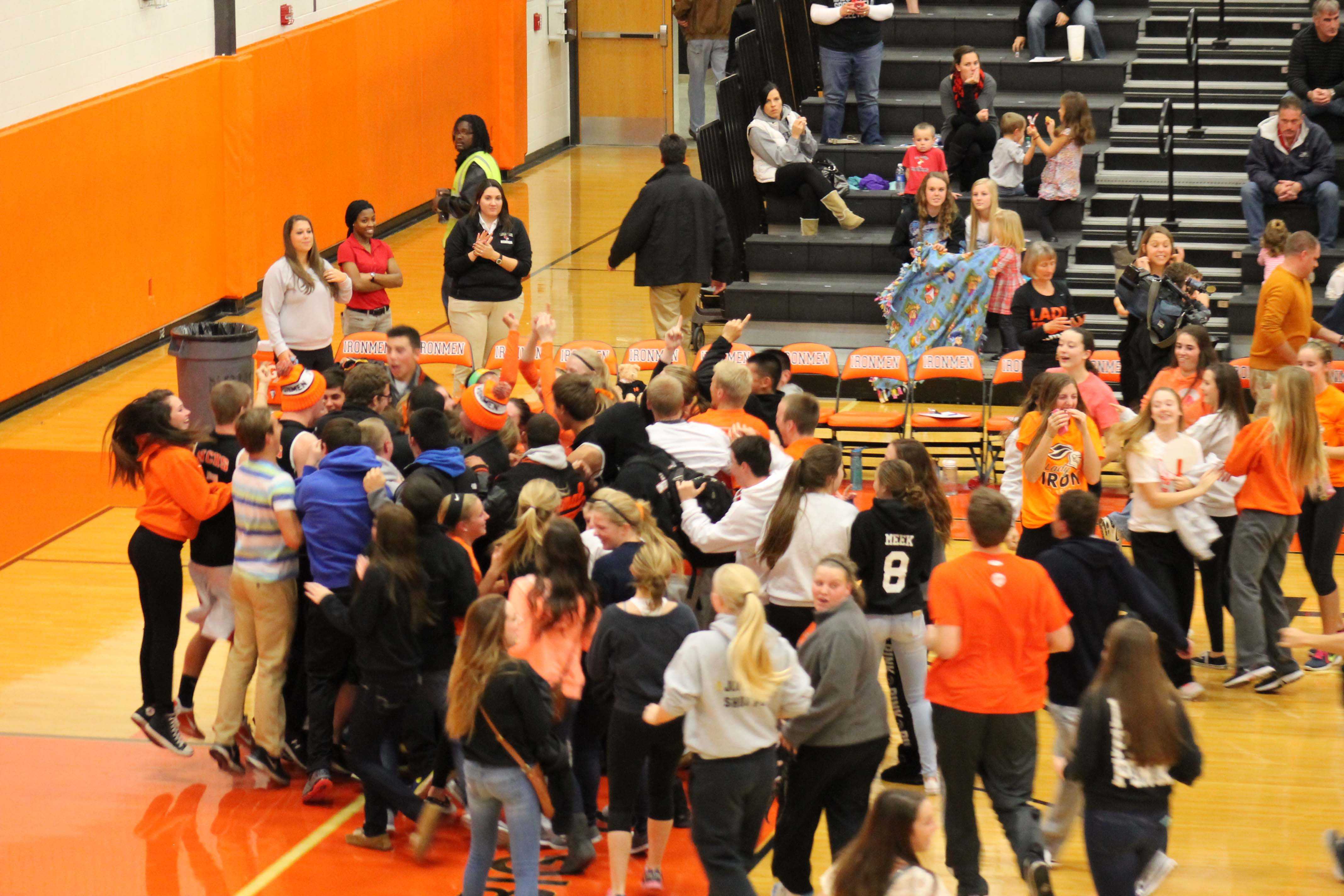 Normal Community fans storm the court to celebrate Lady Iron's Sectional win over the Senators.