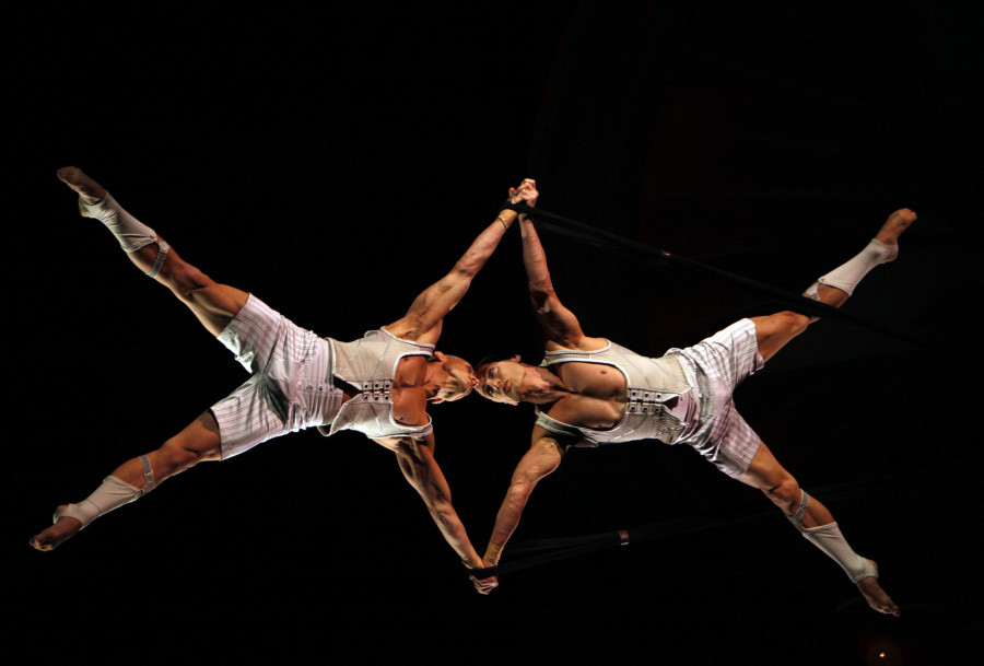 Performers float above the crowd at the Kodak Theater in Los Angeles, California, during a performance of Iris by Cirque du Soleil that honors the craft of filmmaking on September 23, 2011. 