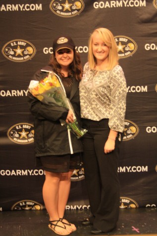 Ashlyn Martin (12) and her coach, Hannah O'Flynn pose together after the ceremony celebrating Ashlyn's acceptance into the Army Band.