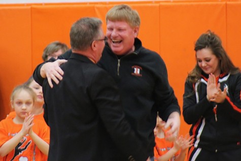 Principal Dave Bollmann embraces Andy Turner during the Feb. 12 basketball halftime ceremony honoring the Athletic Director's accomplishments. 