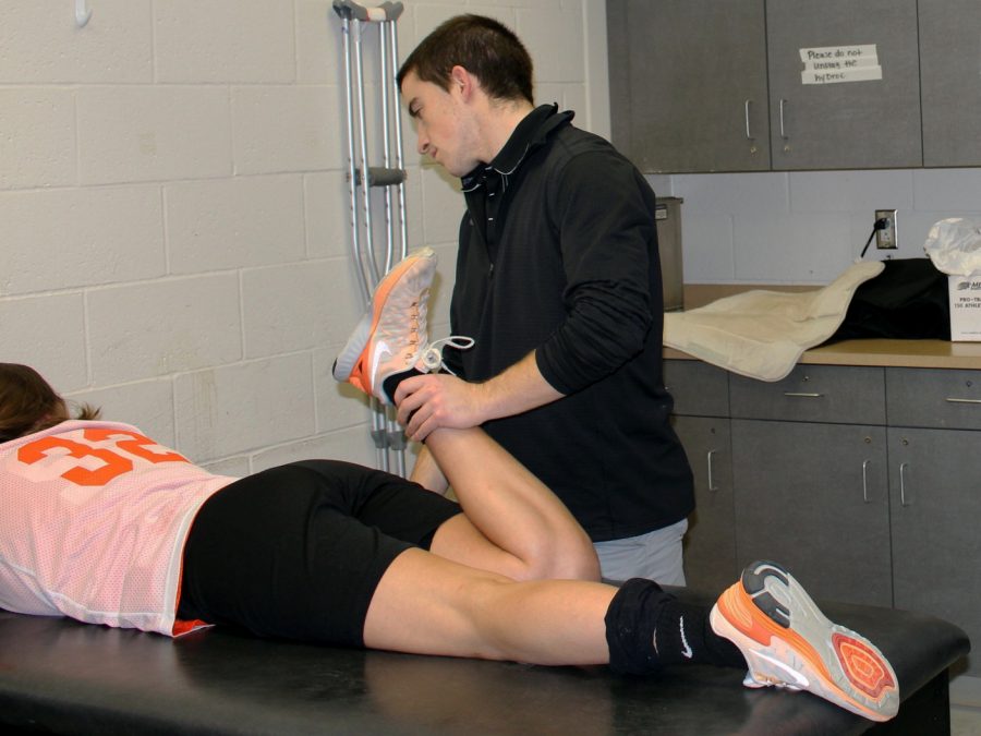 Henry working with an athlete to get her back to 100 percent. 