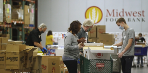 Volunteers fill boxes of food at Midwest Food Bank in Normal. Increased unemployment caused by COVID-19 meant that the packing and distribution of food was essential.