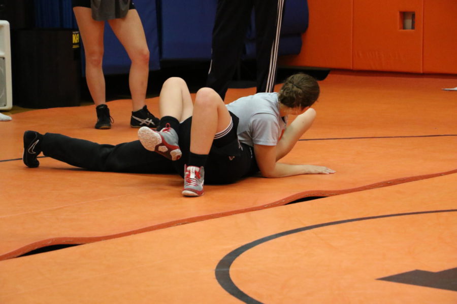 Pyper Wood (23) demonstrates how to pin an opponent with a half nelson.