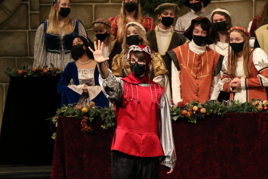Schill holds up five fingers as the choir sings the five golden rings lyric  in The Twelve Days of Christmas. Schill and Speirer, the madrigal wench, acted out each of the twelve days in a theatrical performance accompanied by the choir.