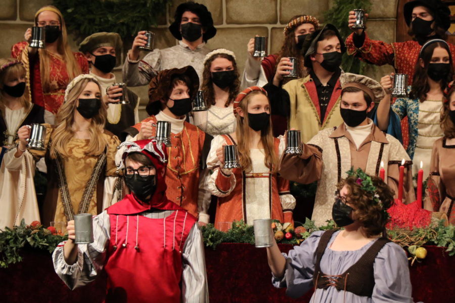 The jester and wench, along with the members of the madrigal choir, lift their medieval tankards in a toast. Guests were offered a glass of wassail (apple cider) when entering the event to participate in the toast. Following the toast, the madrigal choir sang Gloucestershire Wassail and Wassail Song.