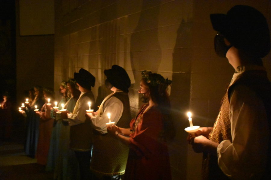 The court singers lined the walls of the dark auditorium, each with their own candle, while the madrigal singers performed Silent Night on stage.