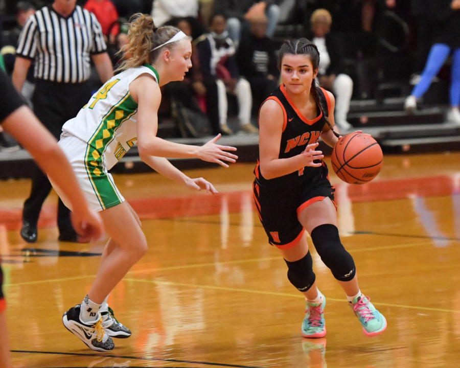 Senior Sophia advances the ball up court in the season opener win over U-High.
Feeney averages 7.1 points per game, and leads the Iron in assists (18), steals (20) and deflections (20).