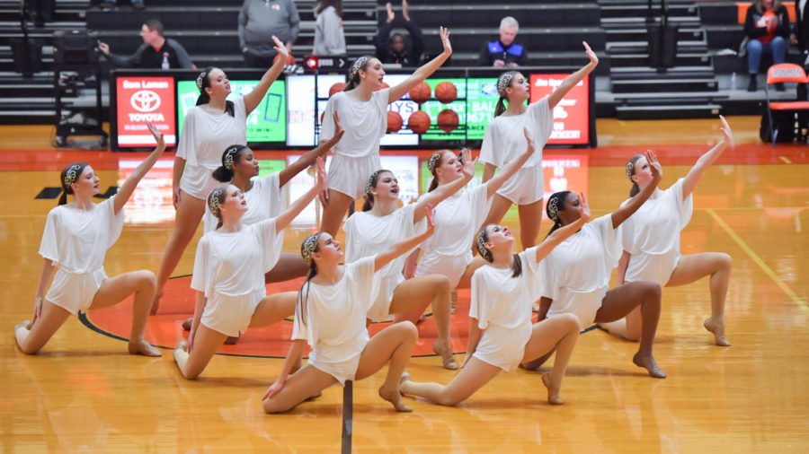 The Iron dance team performs during halftime of a home basketball game. This season the team add performances during Communitys home football games to their schedule for the first time.