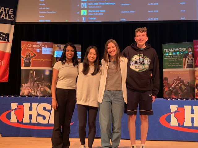 Avani Rai, Kellie Chen, Abby Ruebush and Dylan Wehmeyer pose on stage at the IHSA State Journalism competition. The four were joined by Marielsie Iglesias in the annual State Final at Heartland Community College. 