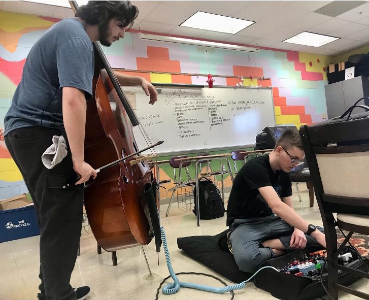 Gabe Martinez (left) runs his cello through effects run by Charles Faulkner (seated). 