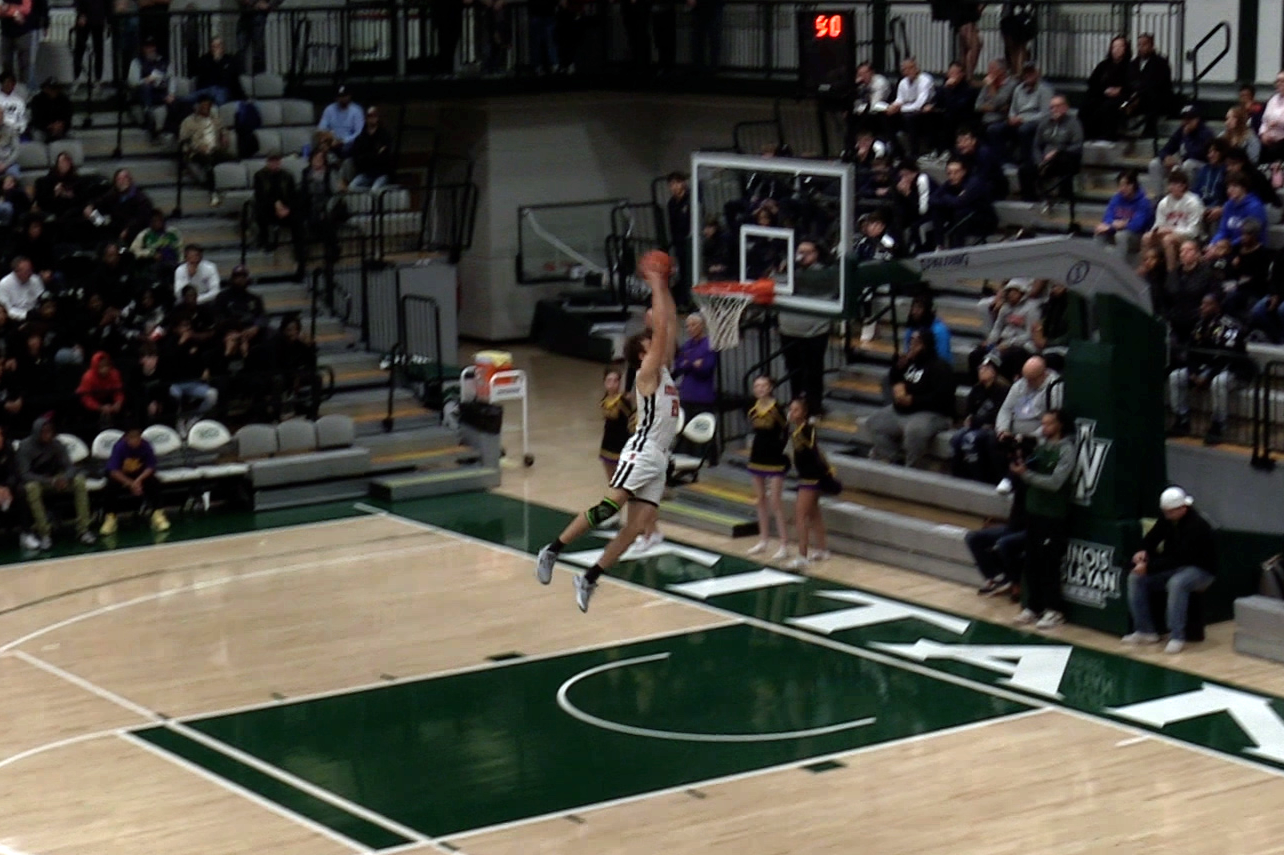 Zach Cleveland through down one of the Ironmens 11 combined dunks in their season-opening win over the Bloomington High School Raiders on Nov. 20. 
Photo Courtesy of: Mr. Brad Bovenkerk