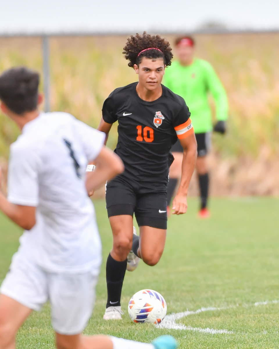 Defenseman Cassius Sharp, shown here in an early season contest against Quincy, was the Iron's scoring leader through the first fourth of the season. 
While the senior saw more time in the backfield in the second half of the 2024 campaign, he put his offensive skills on display by giving Community a 1-0 lead in the regional semis. 
Photo Courtesy of: Mr. Jeff Christopherson