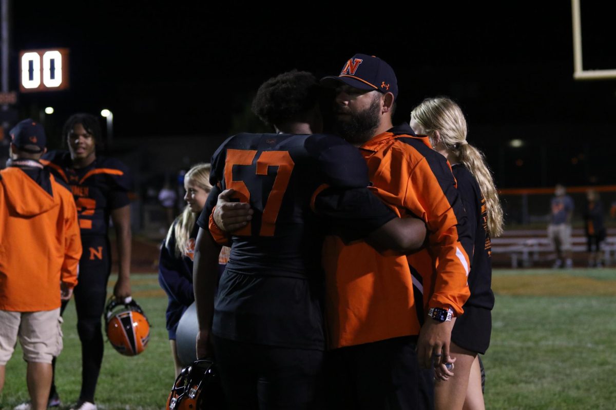 Senior lineman Jeremiah Sawyer embraces a coach after stepping up in Community’s Week 1 win. 
Sawyer saw extended action after an injury sidelined all-conference defensive lineman Damarion Gardner.