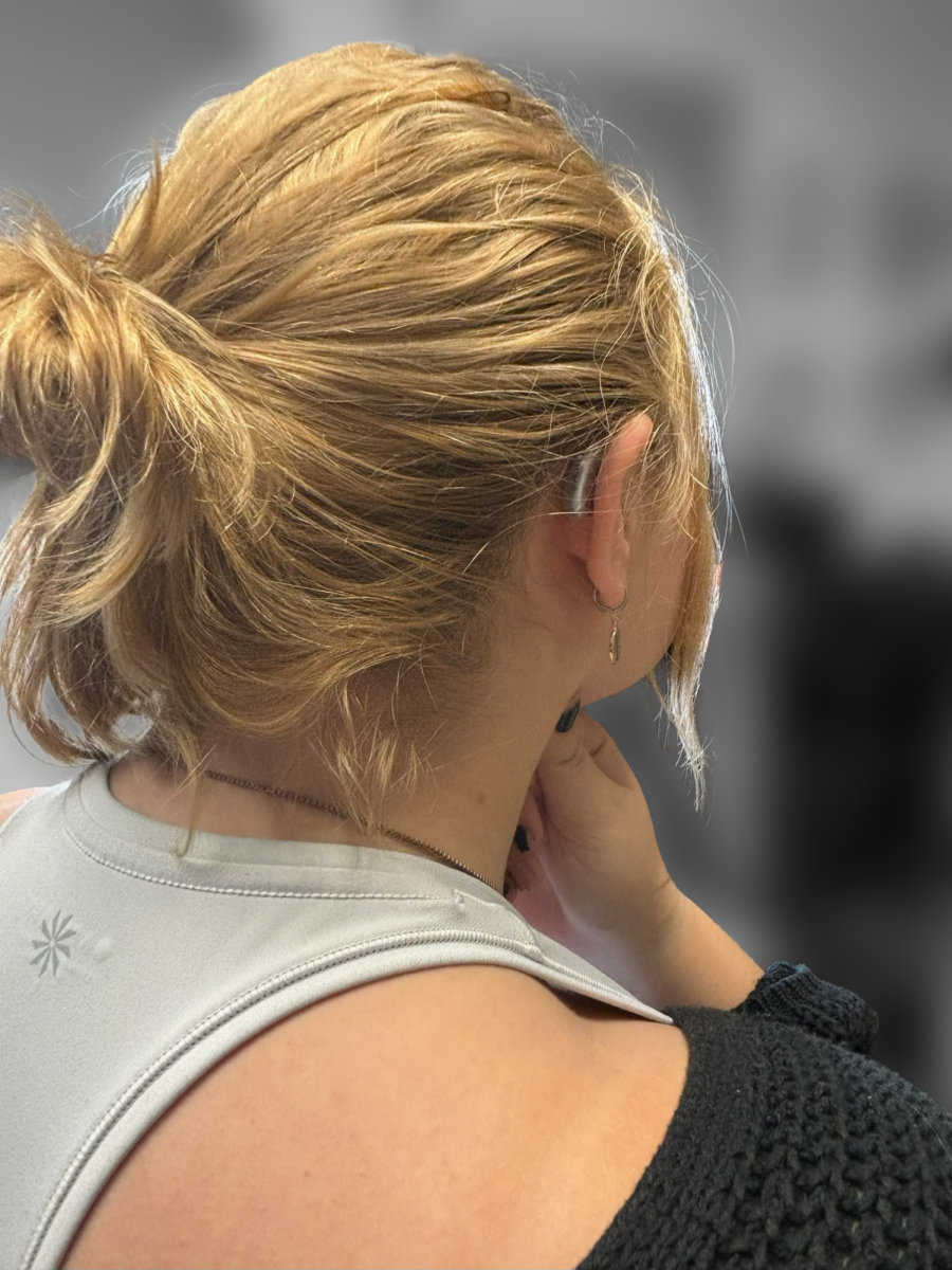 A hearing aid rests behind the author’s right ear, despite being barely visible with her hair down it is changing how she navigates life. 
