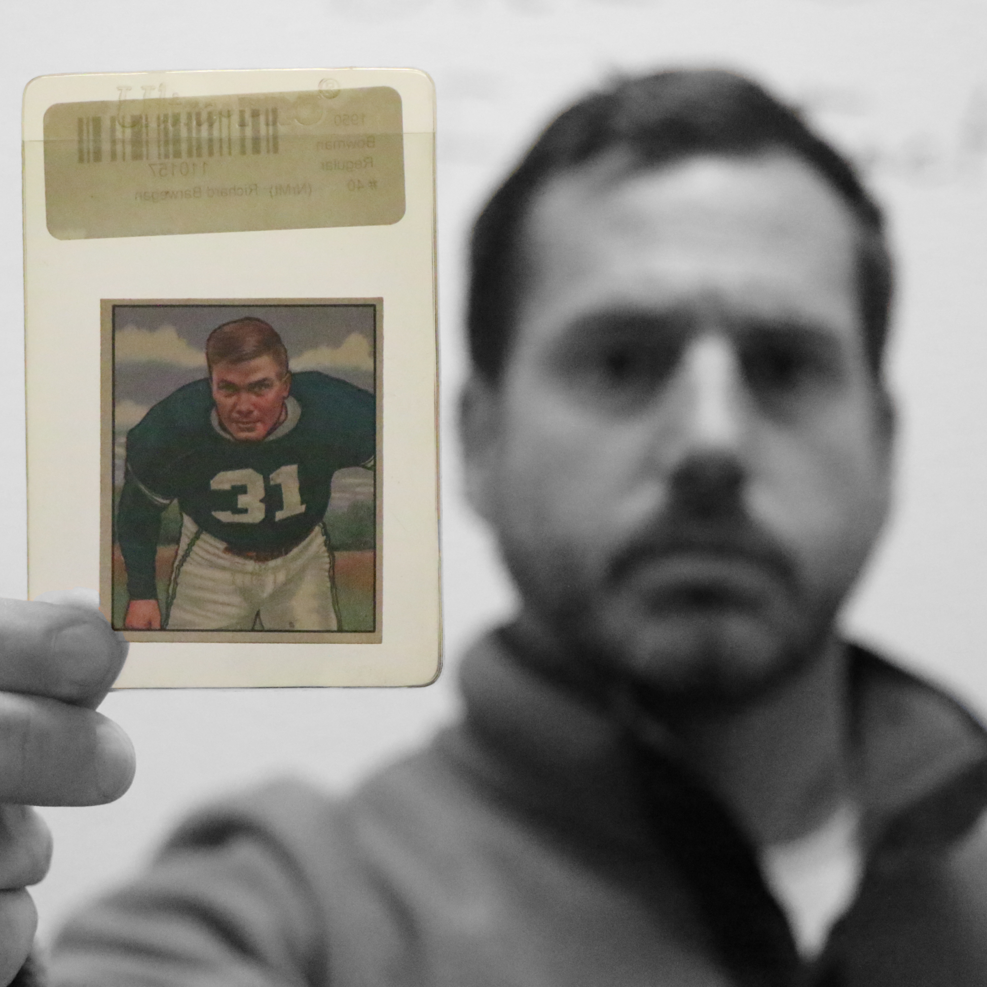 Mr. Brad Bovenkerk poses with a vintage trading card featuring his great-uncle, a former Chicago Bear.