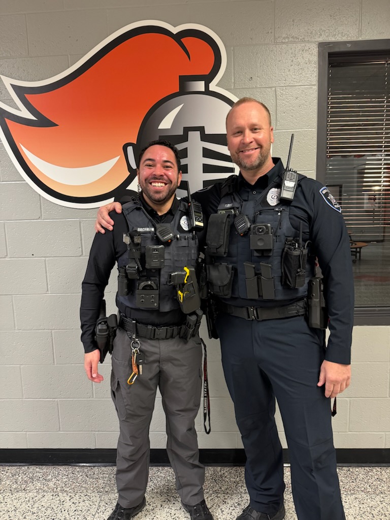 Officer Jeremy Flood (right) poses with his replacement Officer Darien Bachman (left).