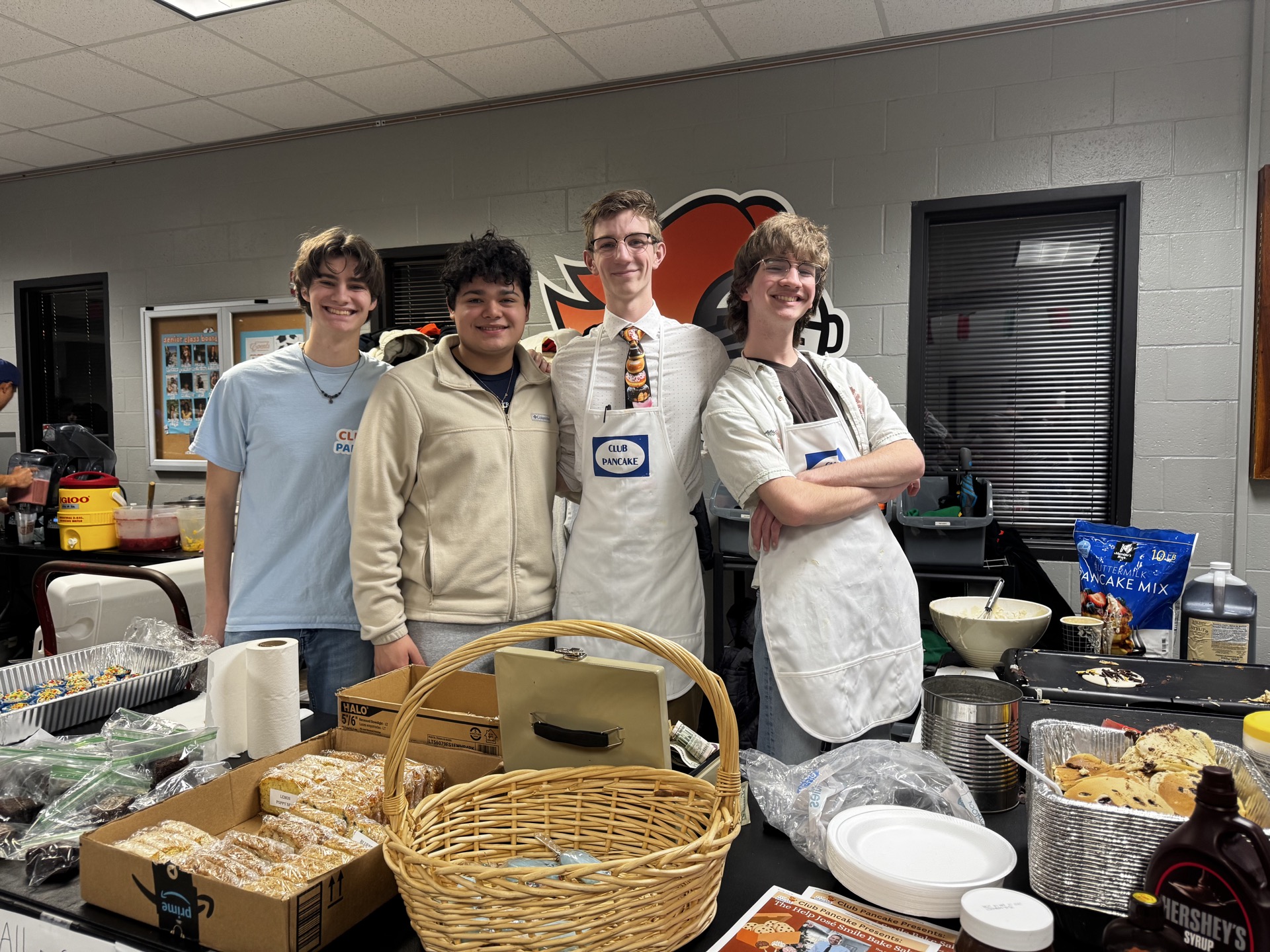 Miguel Patiño-Diaz, second from left poses with Tommy Wade, third from left, during March 13's fundraiser.