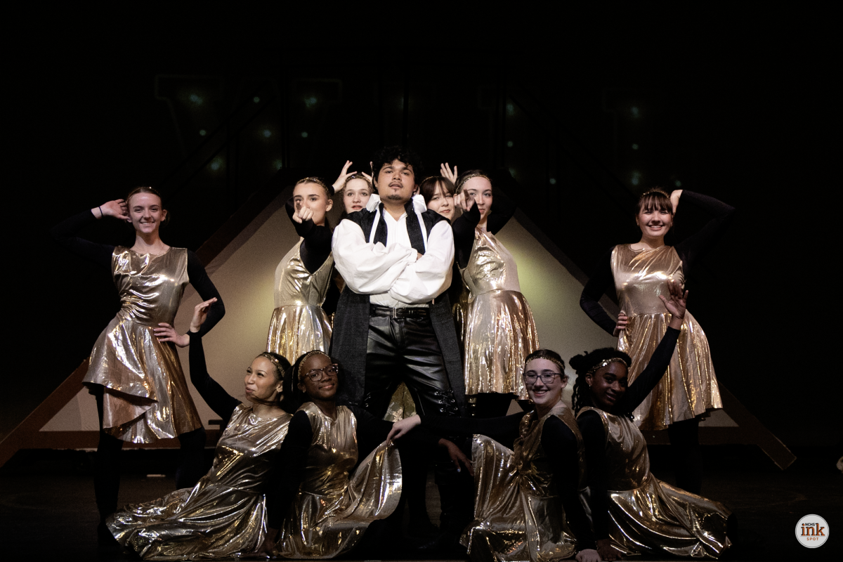 Senior Miguel Patiño-Diaz, center, performs as Shakespeare alongside featured dancers during a production number.